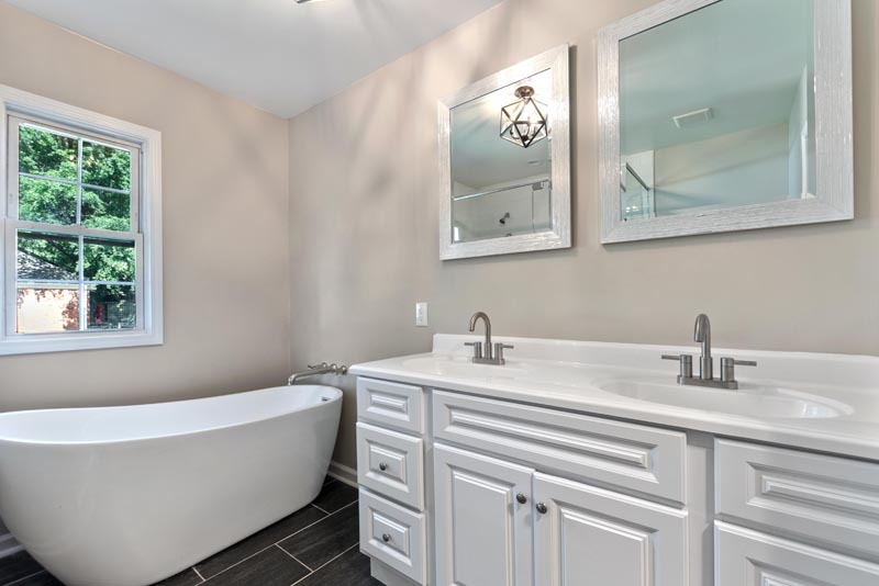 modern bathroom remodel with double sink and large bathtub